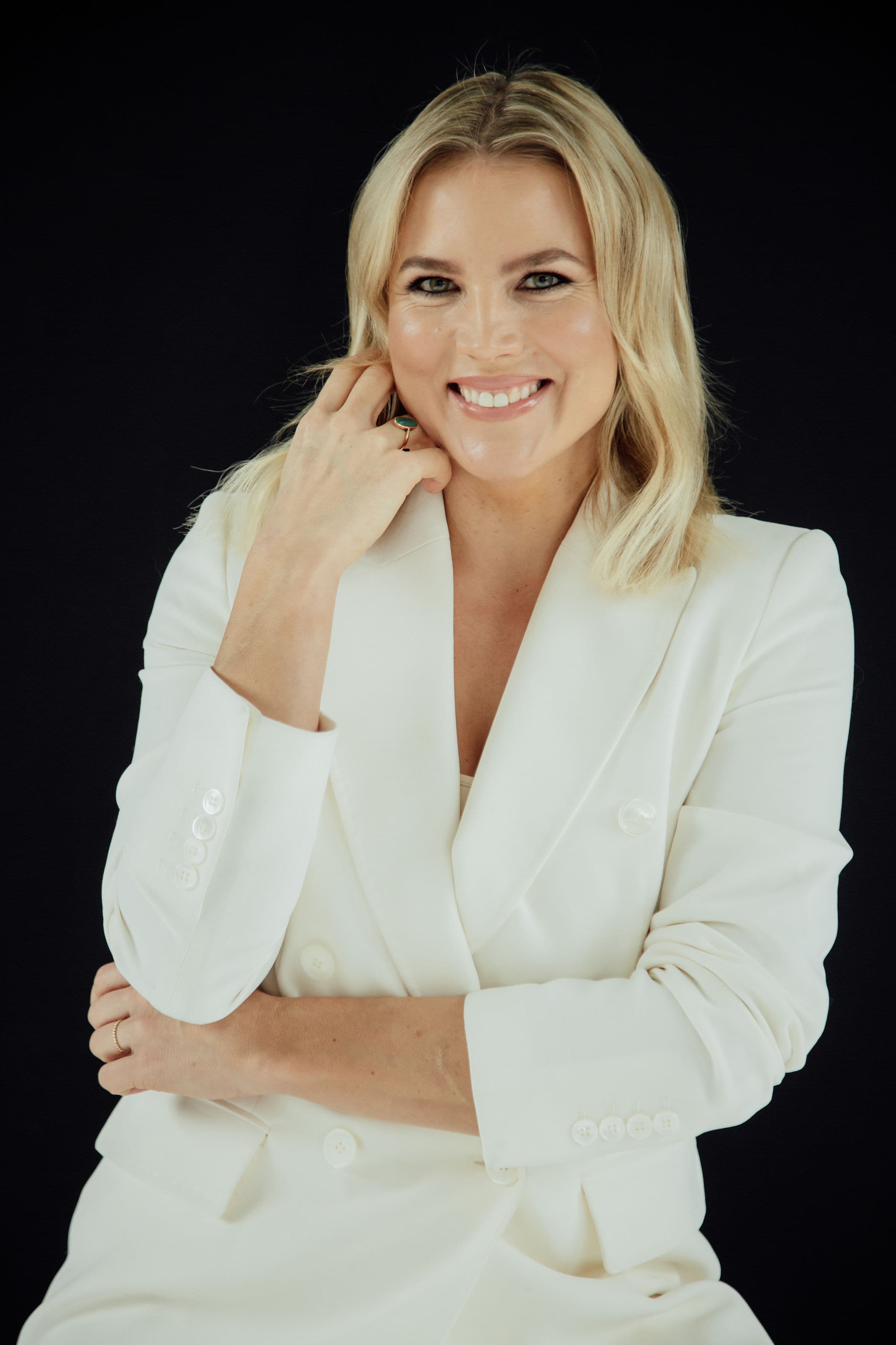 Dr. Emilia Vuorisalmi in a white blazer, studio portrait by Olga Poppius