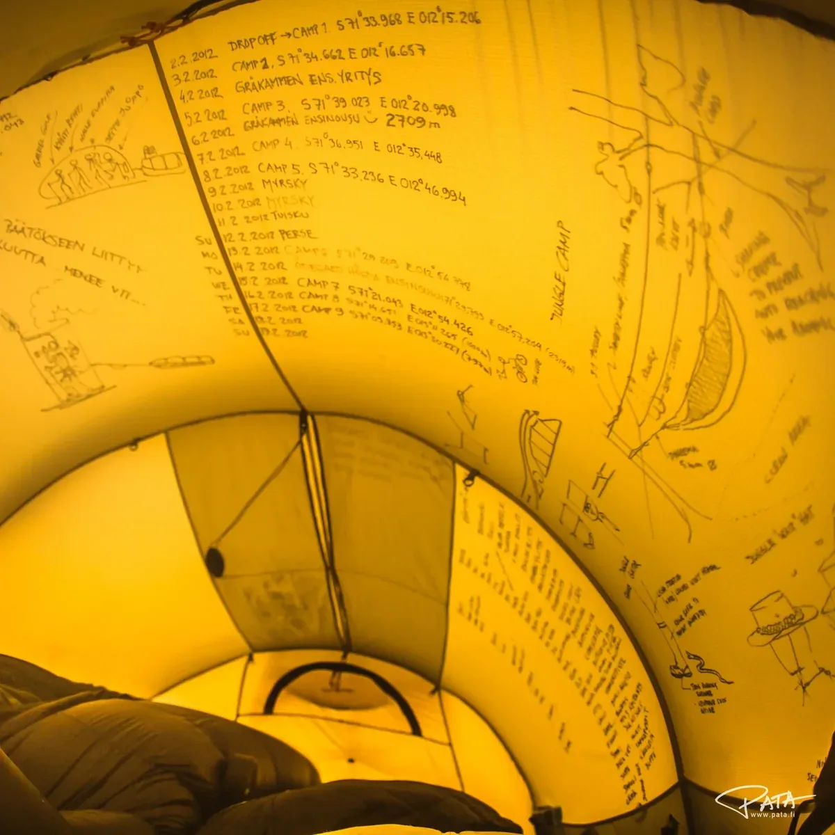 Handwritten expedition log inside a tent with dates, coordinates, and route notes
